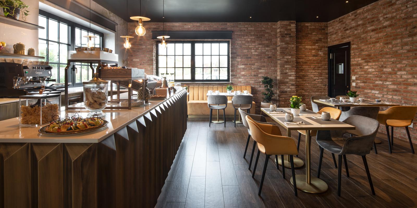 Cozy cafe with brick walls, warm lighting, and modern wooden furnishings.